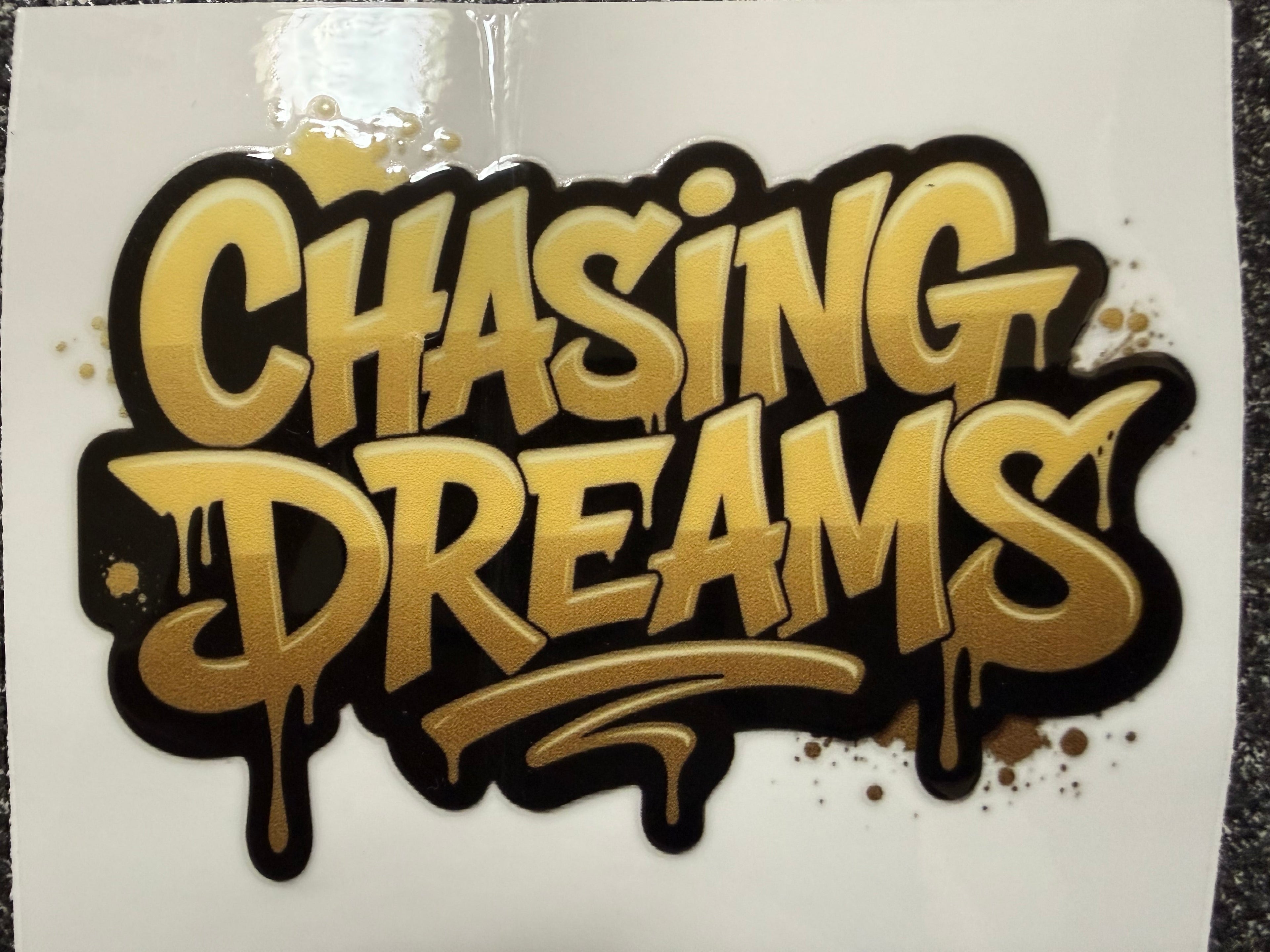 Gold and black 'Chasing Dreams' text on a white background